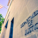 Department of Justice building with American flag.