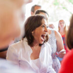 Kamala Harris smiling joyfully in crowd.