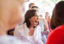 Kamala Harris smiling joyfully in crowd.