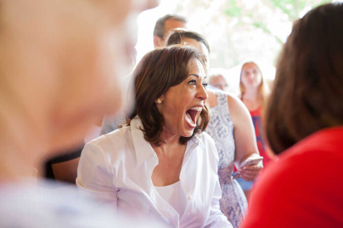 Kamala Harris smiling joyfully in crowd.