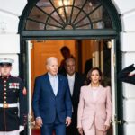 Joe Biden and Kamala Harris exit building with guards.