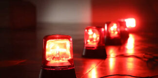 Red emergency lights on dark floor, illuminating the area.