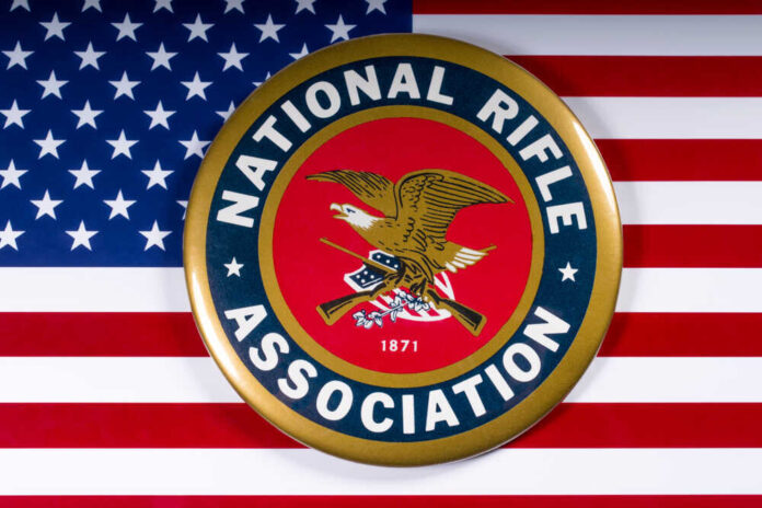 National Rifle Association logo on American flag background.