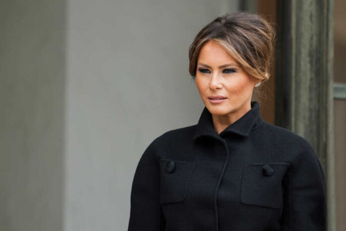 Melania Trump in black coat.