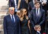 Donald and Melania Trump in formal attire standing outside on steps.