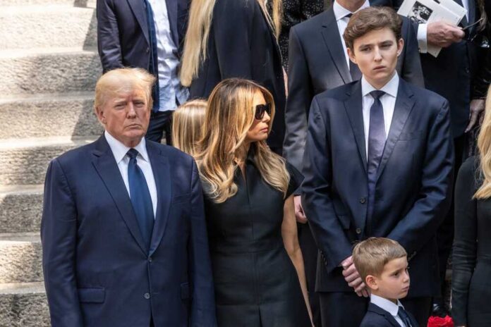 Donald and Melania Trump in formal attire standing outside on steps.