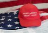 Red Make America Great Again hat on American flag