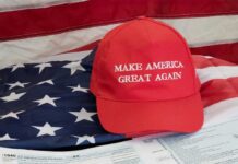 Red Make America Great Again hat on American flag