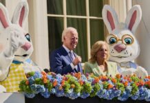 Joe and Jill Biden with Easter Bunny costumes and flower decoration.