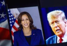 Kamala Harris and Donald Trump on screens, American flag.