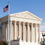 U.S. Supreme Court building with American flag.