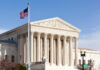 U.S. Supreme Court building with American flag.