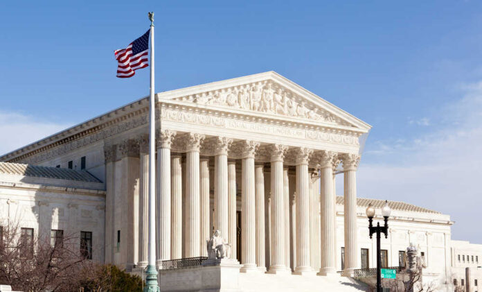 U.S. Supreme Court building with American flag.