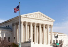 U.S. Supreme Court building with American flag.