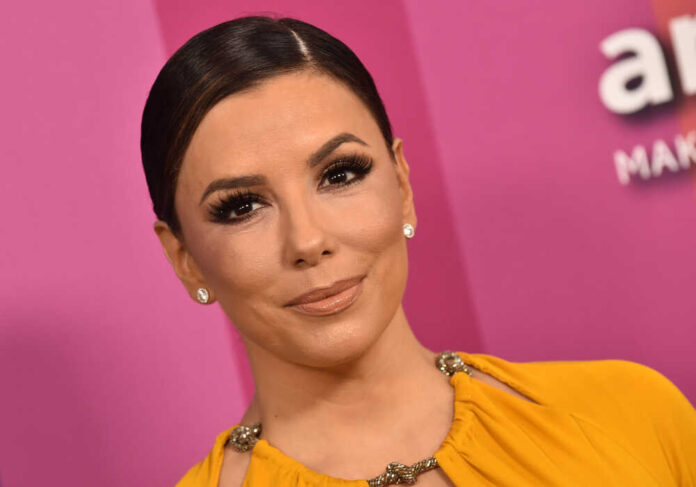 Person smiling against a pink background.