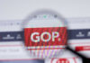 Magnifying glass focusing on GOP website logo.