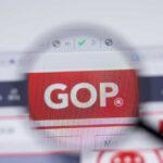 Magnifying glass focusing on GOP website logo.