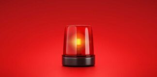 Red emergency light flashing on a red background.