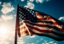 American flag waving against a bright sky.