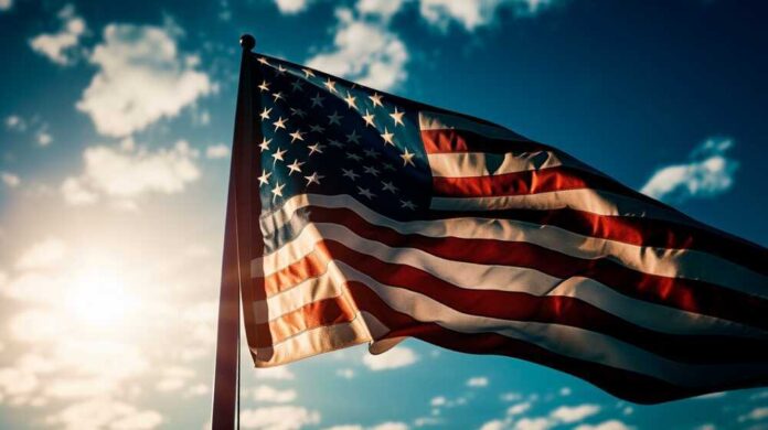 American flag waving against a bright sky.