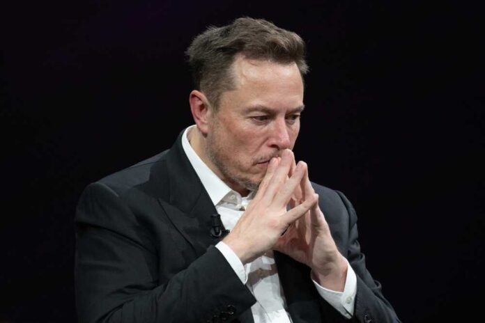 Elon Musk in a suit deep in thought, black background.