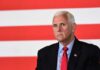 Mike Pence against flag backdrop.