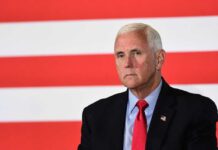 Mike Pence against flag backdrop.