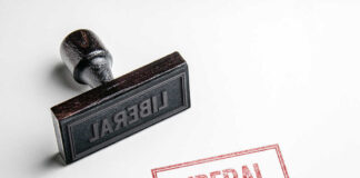 Rubber stamp with the word LIBERAL.