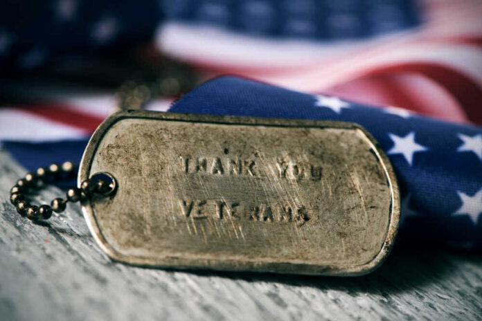 Rusty Veteran's badge with American flag behind