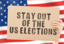 US flag with stay out of the US elections ad.