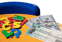 Table with a child tax credit check on it and children's toys.