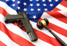 Gun and gavel on a U.S. flag.