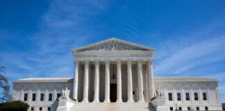 U.S. Supreme Court building under clear blue sky.