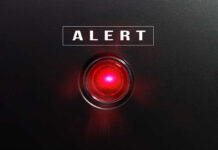 Red alert light against black background, text ALERT.