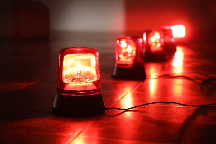 Red emergency lights on a dark floor