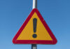 Triangular warning sign with exclamation mark.