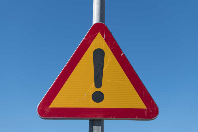 Triangular warning sign with exclamation mark.