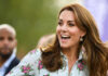 Kate Middleton in a floral blouse outdoors.