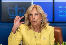 Jill Biden yellow speaking and gesturing with hand