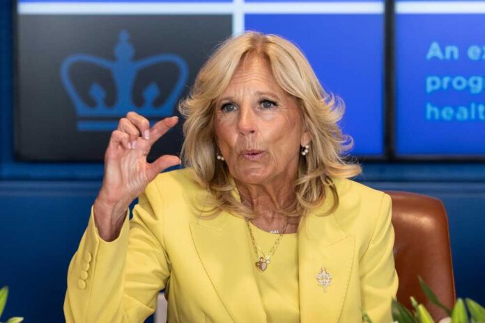 Jill Biden yellow speaking and gesturing with hand