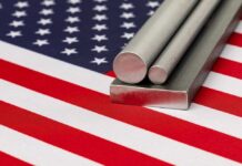 Steel stock on flag of United States of America. Steel manufacturing, production and trade concept.