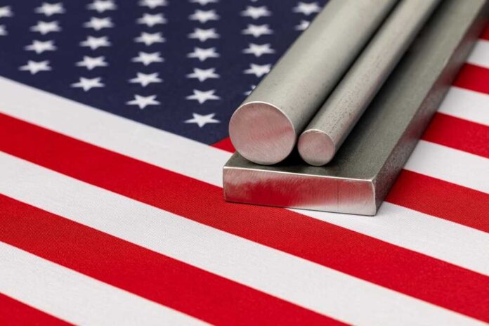 Steel stock on flag of United States of America. Steel manufacturing, production and trade concept.