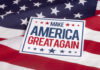 Sign saying Make America Great Again on American flag.