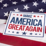 Sign saying Make America Great Again on American flag.