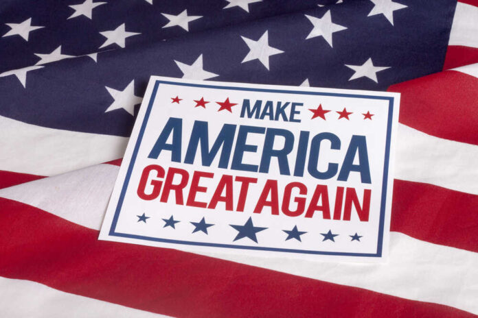 Sign saying Make America Great Again on American flag.