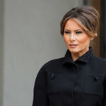 Melania Trump in black coat.