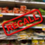 Recall notice over grocery store shelves.