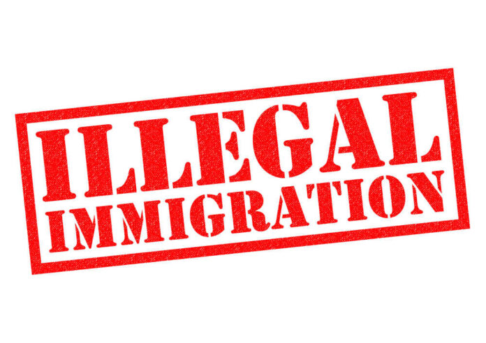 Red illegal immigration stamp on white background