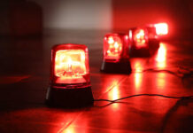 Red emergency lights on dark floor, illuminating the area.