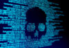 Skull silhouette in blue computer code background.